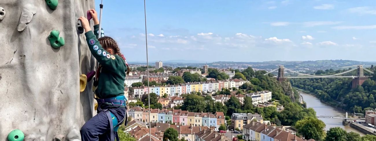 A climber on our mobile climbing wall high above Bristol