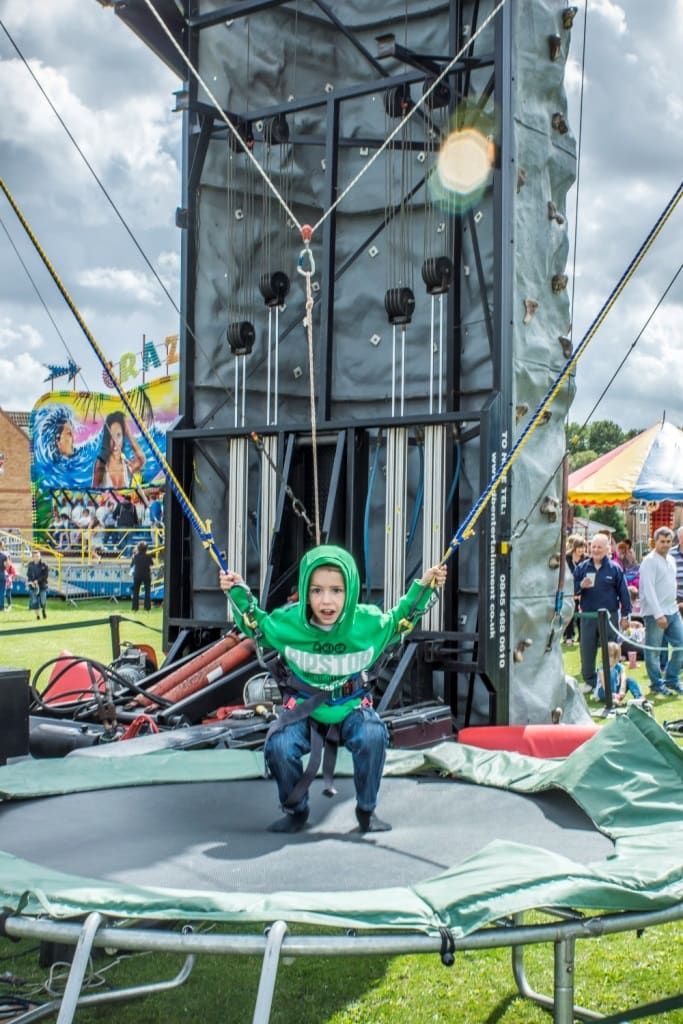 Climbing wall with bungee trampolines attached